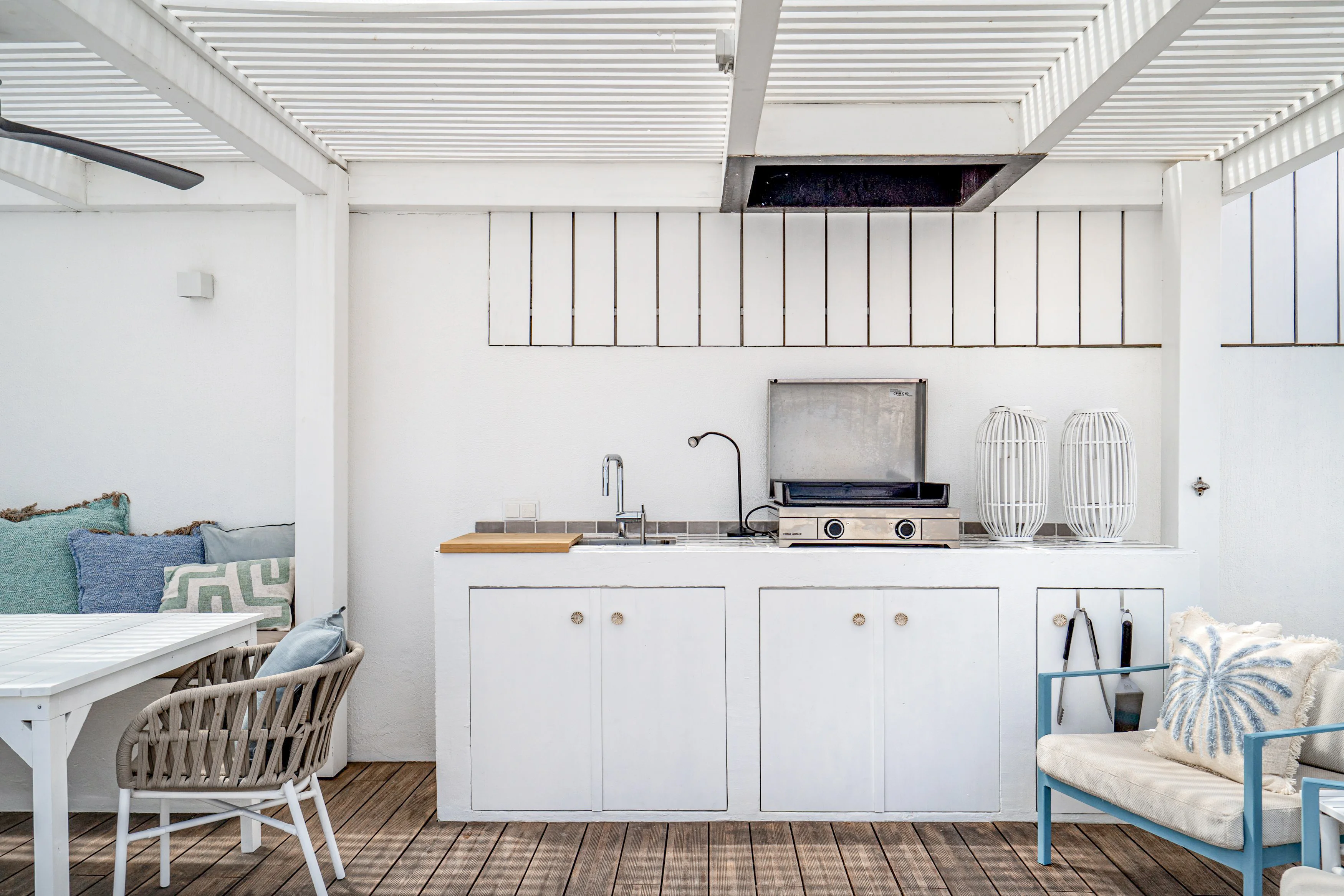 Covered patio with outdoor kitchen featuring stainless steel grill, sink and pergola