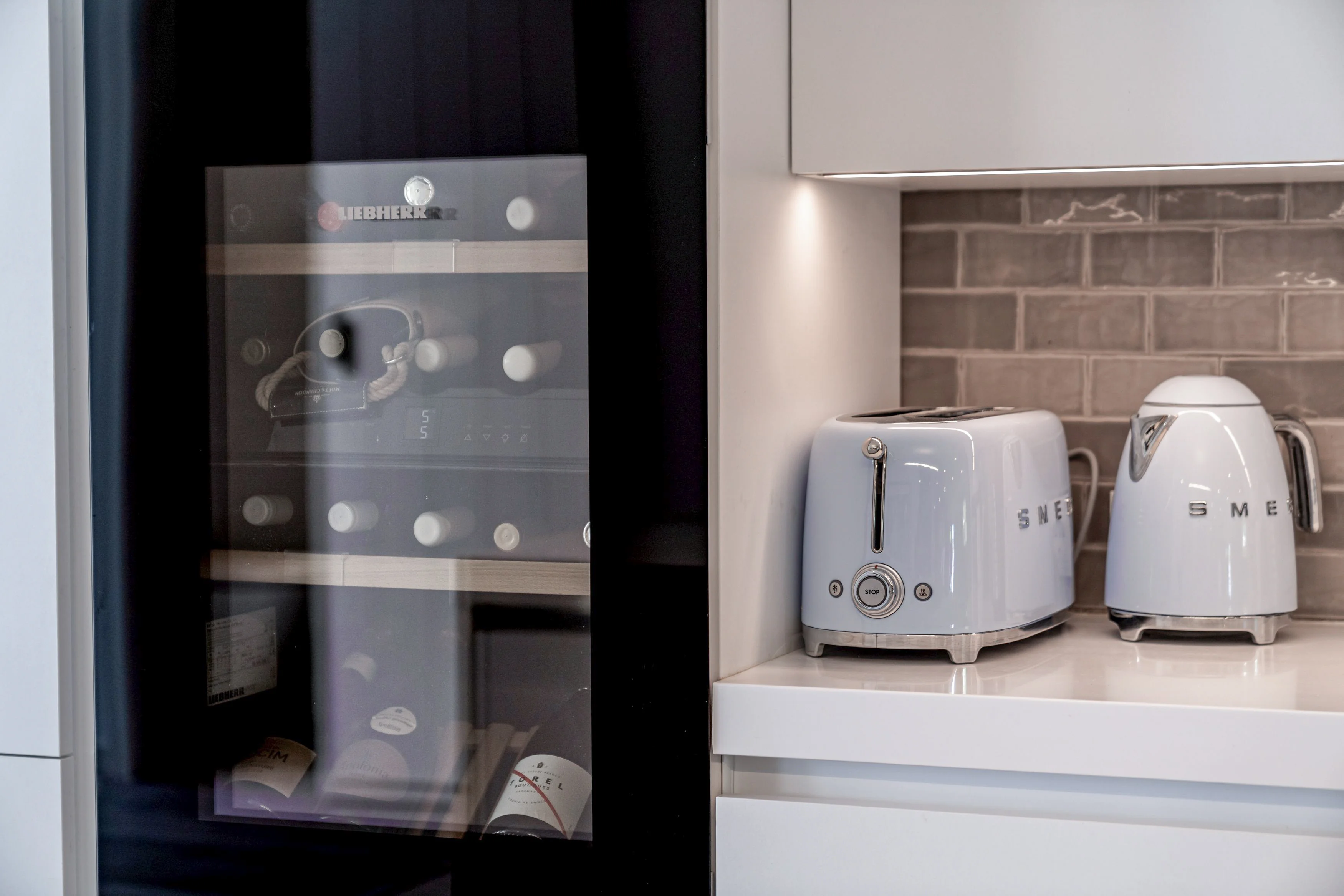 Kitchen detail with Liebherr wine cooler, Smeg toaster and kettle on quartz countertop