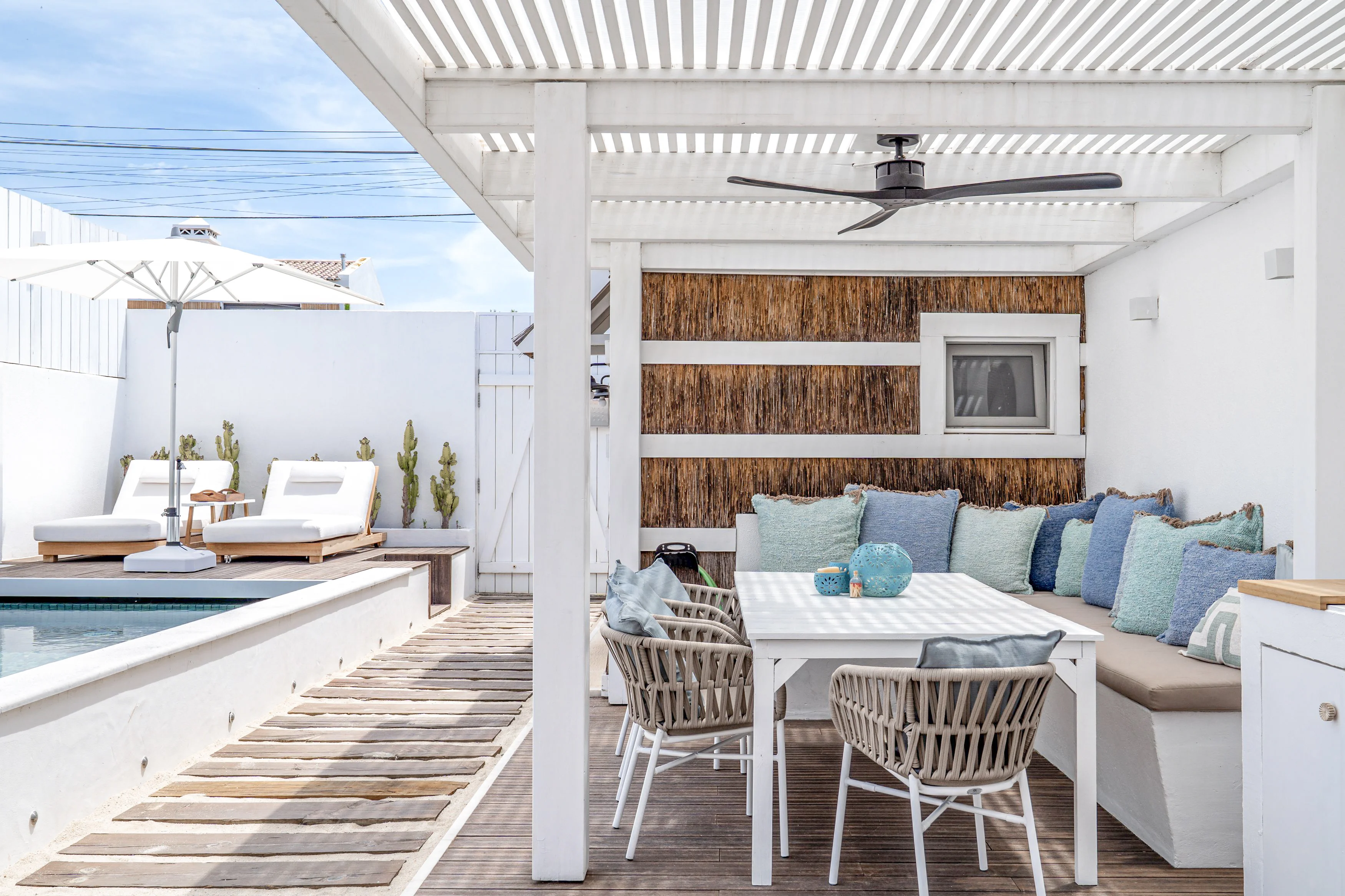 Poolside patio with pergola, dining set, plunge pool and sun loungers